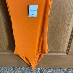Orange mesh body suit